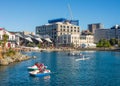 Whairepo Lagoon near Wellington boat shed, Frank Kitts Park and civic square with people boating