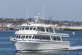 Whale Watcher cruise boat leaving Fairhaven with New Bedford in background Royalty Free Stock Photo
