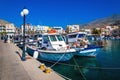 Wharf with citylights and cosy traditional Greek boats in small Royalty Free Stock Photo