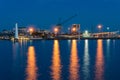 Wharf with crane and lighthouse at dusk Royalty Free Stock Photo