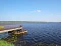 Wharf Dock Metal Wooden Pier on Lake Water Landscape with Blue Sky Royalty Free Stock Photo