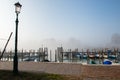 Wharf in quit bay, foggy weather, italian island Burano, province of Venice, Italy. Little beautiful dock with boats, Royalty Free Stock Photo