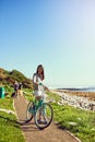 What a beautiful day for a bike ride. Portrait of an attractive young woman riding her bicycle outside. Royalty Free Stock Photo