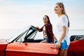 What better way to spend a beautiful summers day. a two happy young women enjoying a summers road trip together.