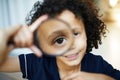 What a big eye you have. a little boy holding a magnifying glass to his eye. Royalty Free Stock Photo