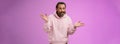 So what bite me. Portrait ignorant careless cool stylish mature bearded man earring pink hoodie shrugging hands sideways