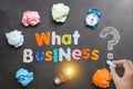 What business to start, question on blackboard with colourful letters, crumpled paper and light bulb