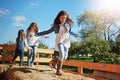 This is what childhood memories are made of. three young sisters playing together on a bale of hay outdoors.