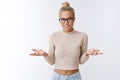 So what, chill. Portrait of unbothered and careless chill attractive glamour blond woman in glasses with bun haircut Royalty Free Stock Photo