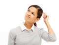 What a conundrum. Studio shot of a young woman scratching her head while thinking isolated on white.