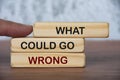 What could go wrong text on wooden blocks with blurred marble background. Fact finding concept