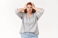 What disaster. Shocked panic redhead woman grab head troubled frowning bothered feel pressured distress facing trouble Royalty Free Stock Photo