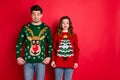 What disgust. Portrait of frustrated two brunette haired students stare at deer christmas tree design jumper displeased