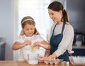 What do I do next. an adorable little girl assisting her mother while baking at home. Royalty Free Stock Photo