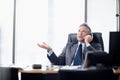 What do you mean we cant meet the deadline. A senior businessman taking a call at his desk. Royalty Free Stock Photo