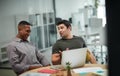 So, what do you think. two young businessmen using a laptop during a meeting in a modern office. Royalty Free Stock Photo