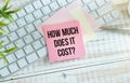 What does it cost, text written in the notebook. Business Concept Royalty Free Stock Photo