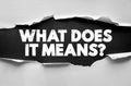 WHAT DOES IT MEANS? text in bold distressed font beneath torn paper, concept of curiosity, explanation, definition, understanding Royalty Free Stock Photo