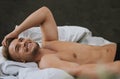 What a dream... a handsome and muscular young man looking thoughtful while lying in his bed at home. Royalty Free Stock Photo