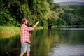 What a fish. mature bearded man with fish on rod. big game fishing. relax on nature. hipster fishing with spoon-bait Royalty Free Stock Photo