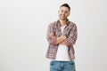 What funny person you are. Indoor portrait of good-looking mature male student with bristle in trendy glasses standing