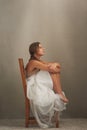 What goes on in that beautiful head...Studio shot of an attractive young woman looking thoughtful while sitting on a Royalty Free Stock Photo