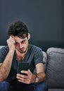 What happened last night. a beaten and bruised young man reading a text message. Royalty Free Stock Photo