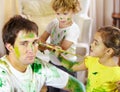 This is what happens when Moms away for the weekend. a dad being painted by his children. Royalty Free Stock Photo