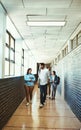 What have you got next. Full length shot of a group of university students walking through a campus corridor. Royalty Free Stock Photo