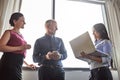 What have you got there. three businesspeople meeting in the office.