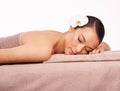 This is what heaven must feel like. A beautiful young woman relaxing on a massage table with her eyes closed.