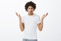 What the hell. Intense clueless handsome hispanic male model with moustache and curly hair, shrugging with hands raised Royalty Free Stock Photo