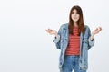 What the hell was that. Portrait of confused misunderstood good-looking girlfriend in denim jacket and striped blouse Royalty Free Stock Photo