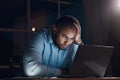 What am I going to do. a young businessman looking stressed while working on his laptop late at night. Royalty Free Stock Photo