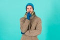 What if. Man handsome unshaven guy wear winter accessories on blue background. Winter season sale. Hipster knitted Royalty Free Stock Photo