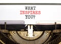 What inspires you symbol. Concept words What inspires you typed on beautiful retro old typewriter. Beautiful white background. Royalty Free Stock Photo