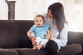 This is what love is all about. an adorable baby girl bonding with her mother on the sofa at home.