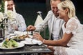 What a lovely couple. Group of adult friends have a rest and conversation in the backyard of restaurant at evening time Royalty Free Stock Photo