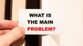 WHAT IS THE MAIN PROBLEM in the hand of a man against the background of books in the house Royalty Free Stock Photo