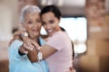 What makes a home are the memories made in it. a senior woman standing next to her daughter and holding up the keys to