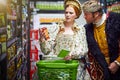 What manner of elixir is this my king. a king and queen looking at goods while shopping in a modern grocery store. Royalty Free Stock Photo