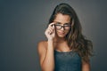 What matters most is how you see yourself. Studio shot of an attractive young woman peering over her glasses against a Royalty Free Stock Photo