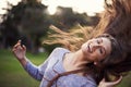 This is what it means to be alive. a beautiful carefree young woman flinging her hair while dancing outdoors.