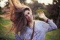 This is what it means to be alive. Portrait of a beautiful carefree young woman flinging her hair while outdoors.
