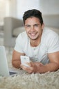 What more could you want for a relaxing weekend in. Portrait of a relaxed young man using a phone and laptop on the Royalty Free Stock Photo
