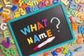 What name for a new baby, question on blackboard with many colorful plastic letters and positive pregnancy test