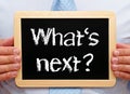 What is next - Manager holding chalkboard with text