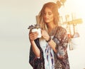 What a perfect little plant. a free spirited young woman admiring a pot plant in her hands. Royalty Free Stock Photo