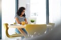 What a pleasure it is to work from home. an attractive young businesswoman sitting alone in her home and using her Royalty Free Stock Photo