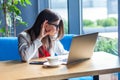 What? Portrait of attentive beautiful stylish brunette young woman in glasses sitting, looking at her laptop screen on video call